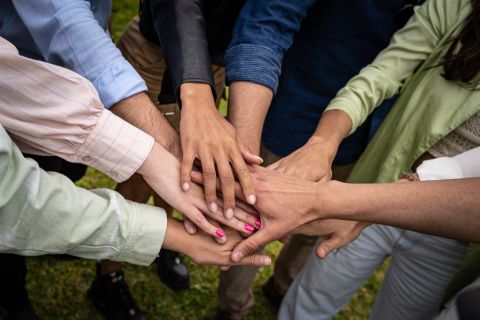 Multicultural young people joining hands in stack - unity and collaboration concept, Photos - Envato Elements