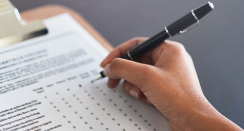 Completing the survey. Cropped shot of an unrecognizable businesswoman filling in a questionnaire