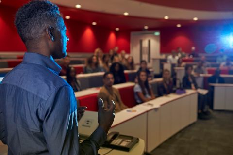 man lecturing students university lecture