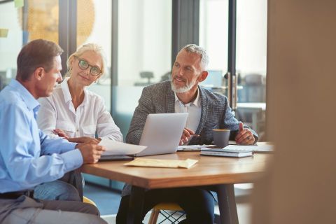 image of 3 colleagues sitting modern office