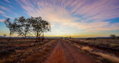 Dramatic view of pink clouds in the steppe at sunset 